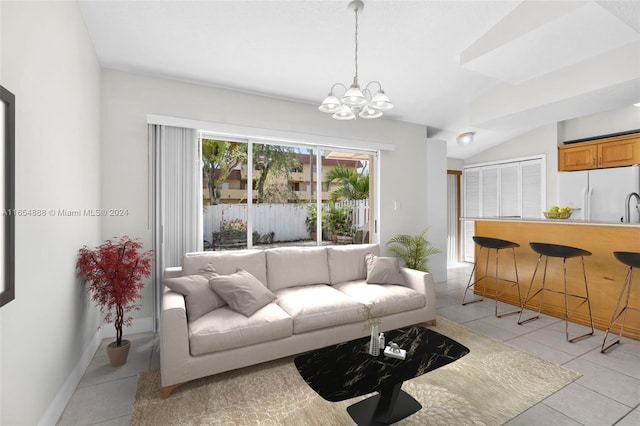 tiled living room with vaulted ceiling, sink, and a chandelier