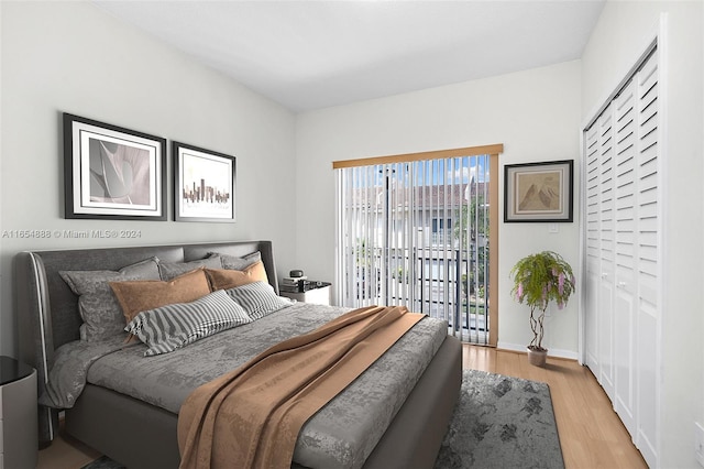 bedroom with light wood-type flooring and access to outside