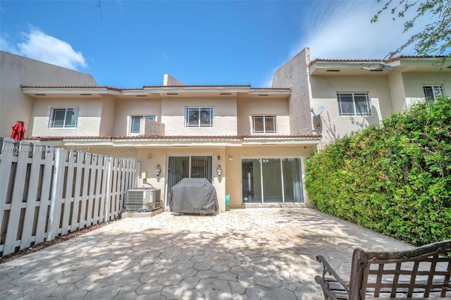 rear view of property with a patio area and central air condition unit