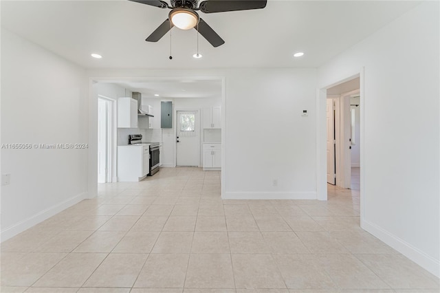 interior space with light tile patterned floors, ceiling fan, and electric panel