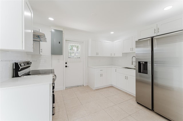 kitchen with stainless steel appliances, ventilation hood, and white cabinetry