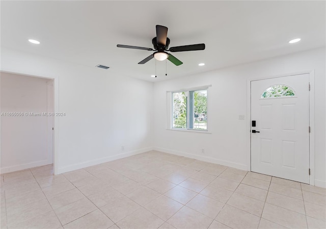 tiled entryway featuring ceiling fan