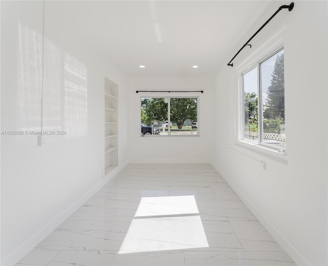 5847 Mayo St, Hollywood, FL 33023 - spare room featuring built in shelves, marble finish floors, baseboards, and recessed lighting