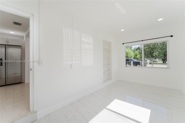 empty room featuring built in shelves