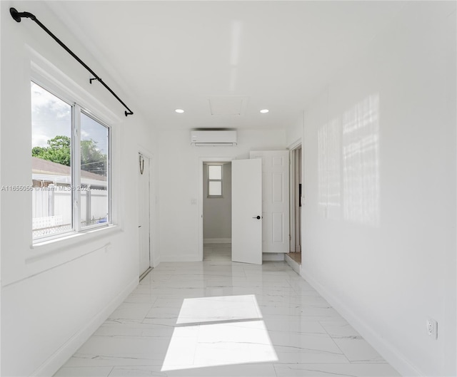 5847 Mayo St, Hollywood, FL 33023 - spare room with an AC wall unit, light marble finish floors, baseboards, recessed lighting, and attic access
