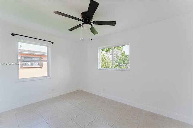 spare room featuring ceiling fan and light tile patterned flooring