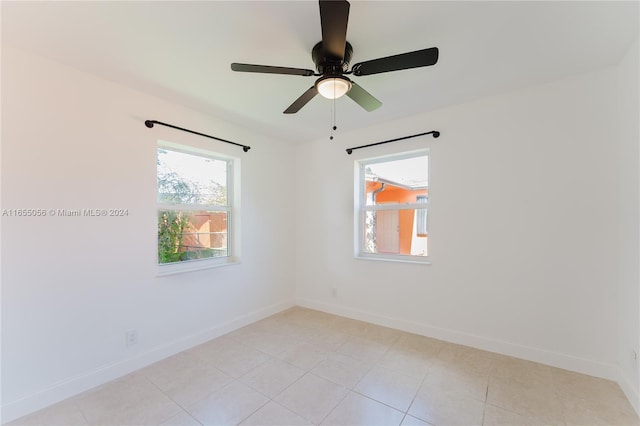 spare room featuring ceiling fan and light tile patterned floors