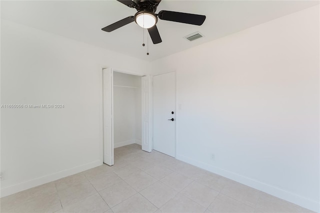 unfurnished bedroom with a closet and ceiling fan