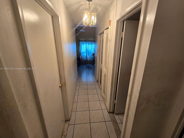 13915 SW 56th Ln Unit 13915, Miami, FL 33183 - corridor featuring light tile patterned floors and a chandelier