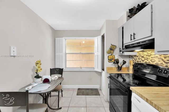 kitchen featuring decorative backsplash, light tile patterned floors, electric range, and white cabinetry