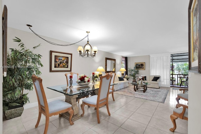 tiled dining space featuring a notable chandelier