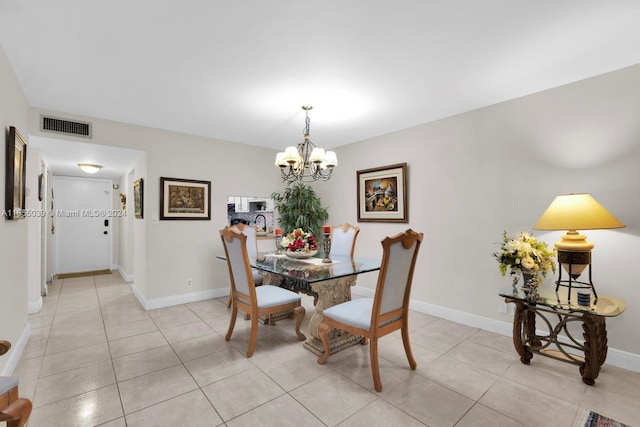 tiled dining area with a chandelier