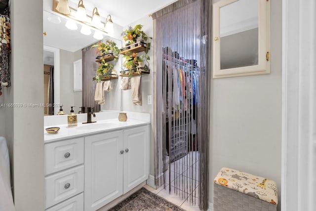 bathroom with tile patterned floors and vanity