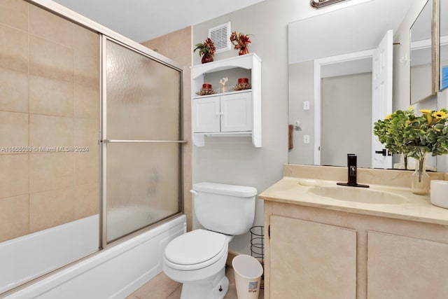 full bathroom with vanity, toilet, tile patterned floors, and bath / shower combo with glass door