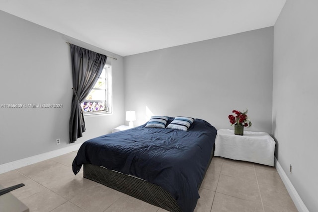 bedroom with light tile patterned floors