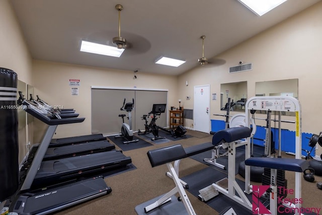 exercise room featuring ceiling fan and vaulted ceiling