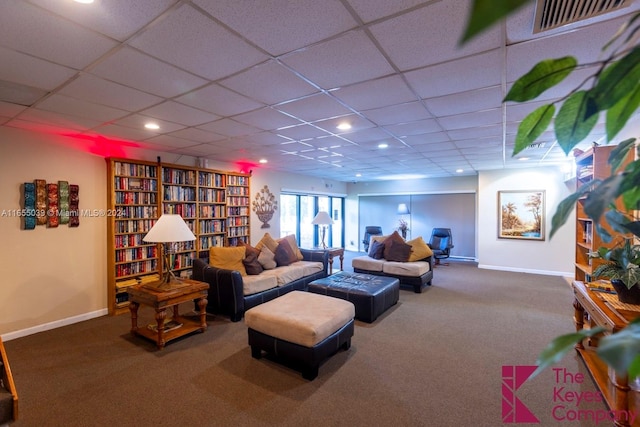 carpeted living room featuring a paneled ceiling