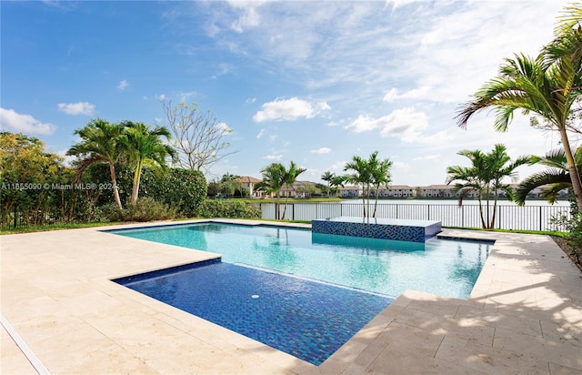 view of pool with a water view and a patio