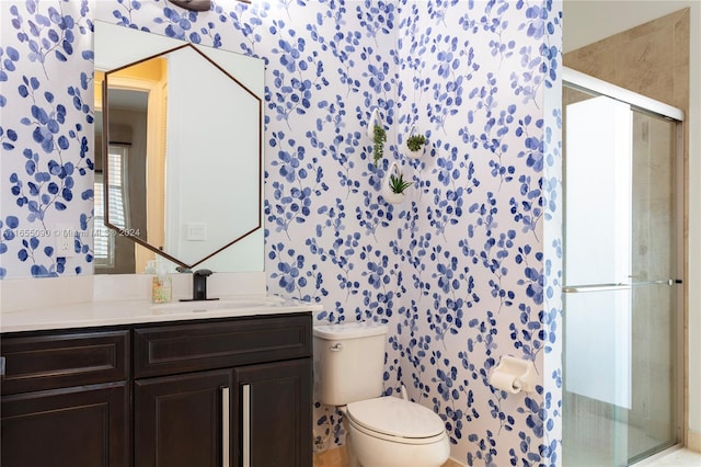 bathroom with vanity, toilet, and walk in shower