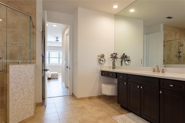 bathroom with vanity, tile patterned floors, and walk in shower