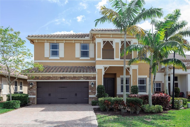 mediterranean / spanish house with a garage