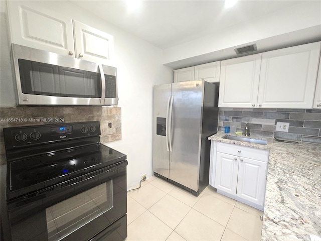 kitchen with stainless steel appliances, decorative backsplash, white cabinetry, and sink