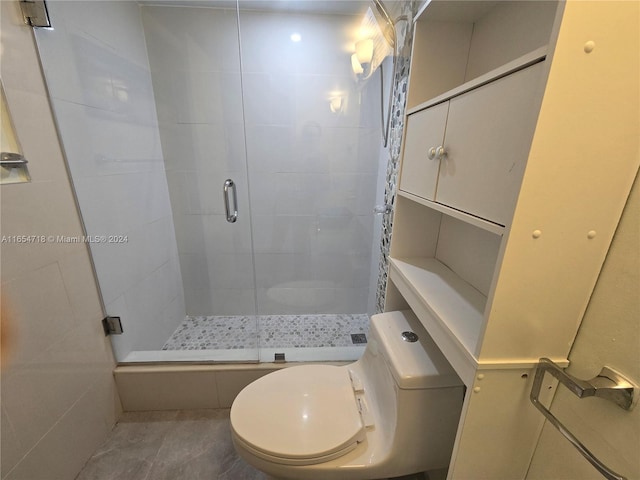 bathroom with toilet, an enclosed shower, and tile patterned flooring