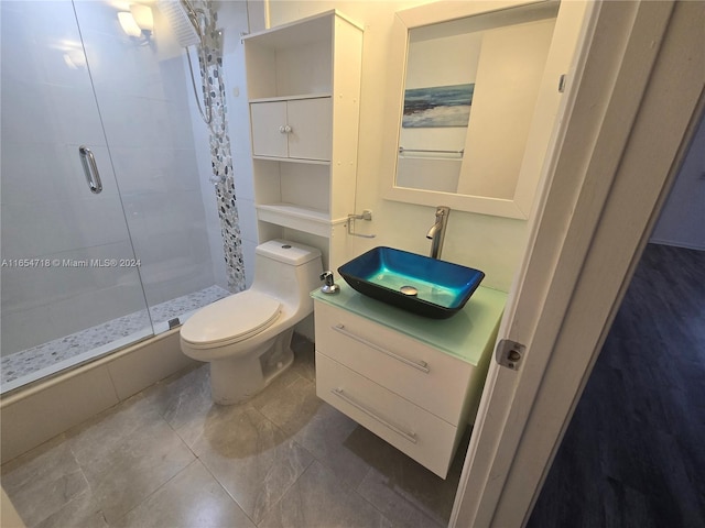 bathroom featuring walk in shower, toilet, and vanity