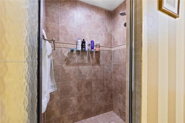 bathroom featuring a shower with shower door