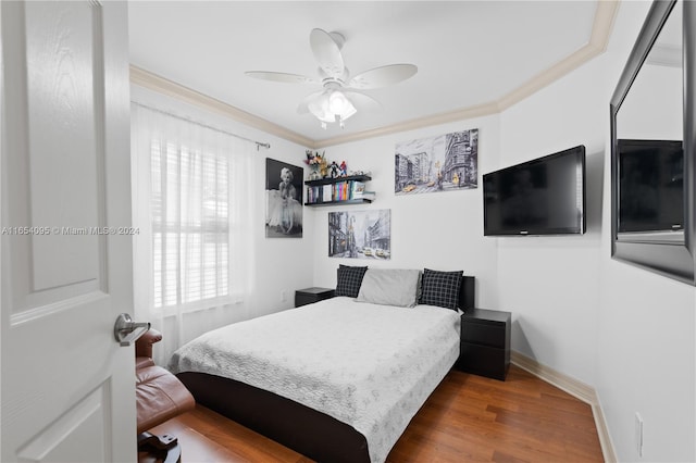 bedroom featuring ornamental molding, ceiling fan, dark hardwood / wood-style floors, and multiple windows