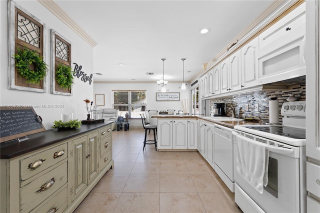 kitchen featuring backsplash, white appliances, kitchen peninsula, pendant lighting, and a kitchen bar