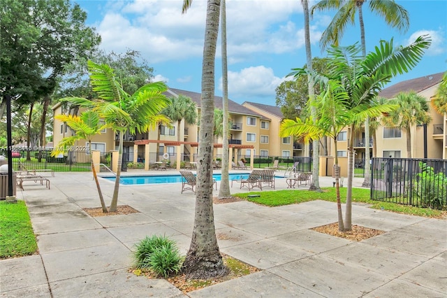 view of home's community featuring a patio area and a pool