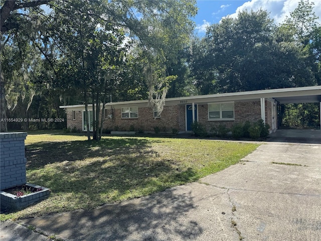 ranch-style house with a front yard and a carport