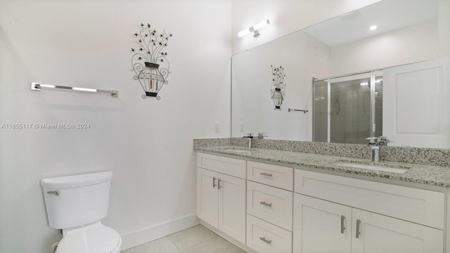 bathroom featuring tile patterned flooring, vanity, toilet, and an enclosed shower