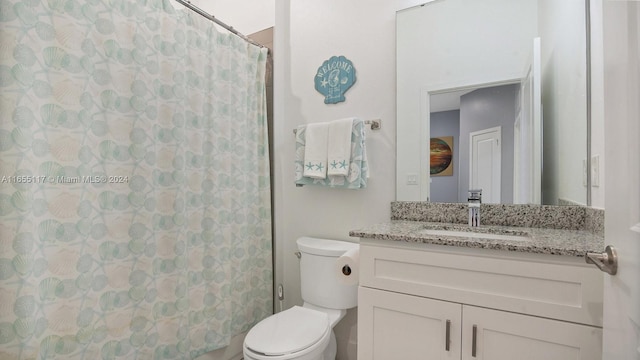 bathroom featuring a shower with shower curtain, toilet, and vanity