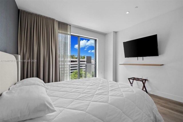 bedroom with access to outside and light hardwood / wood-style floors