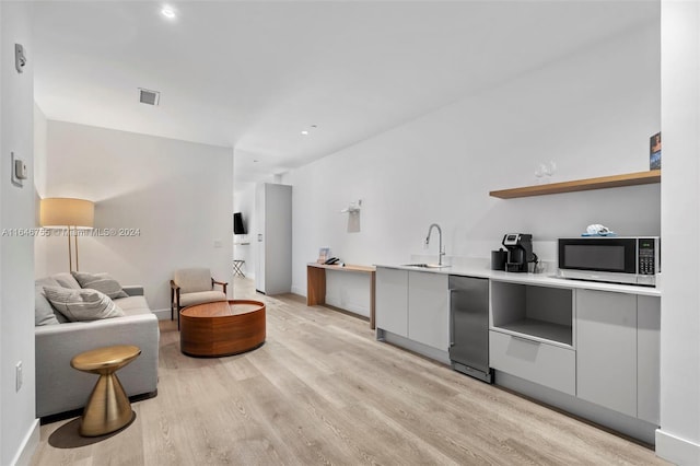 interior space featuring sink and light wood-type flooring