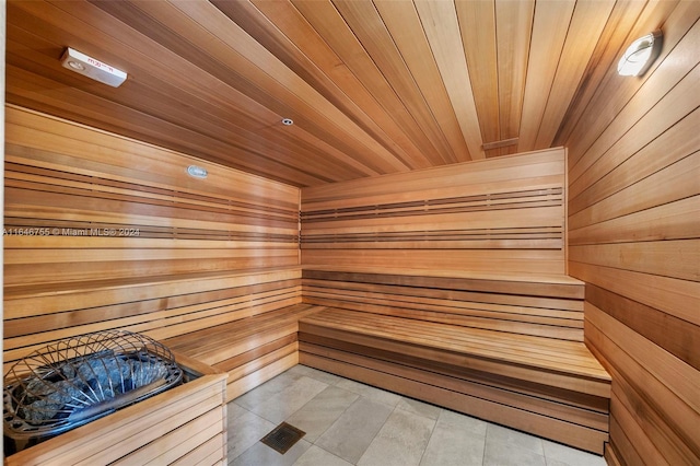 view of sauna featuring wood ceiling and wooden walls