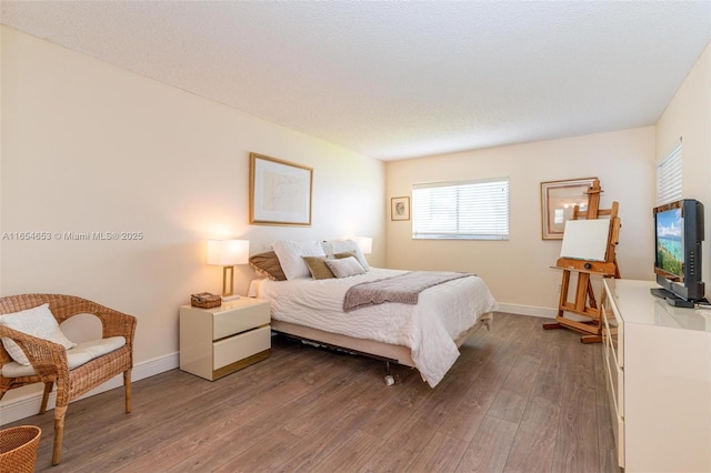 bedroom featuring a textured ceiling and hardwood / wood-style floors