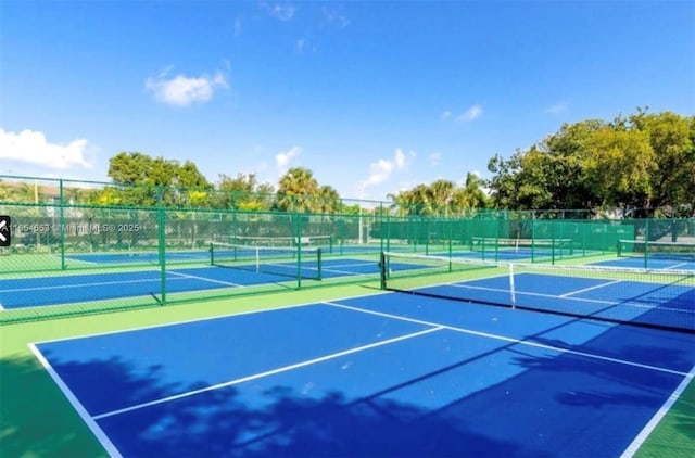 view of tennis court with basketball hoop