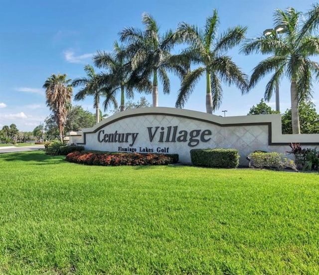 community sign featuring a yard