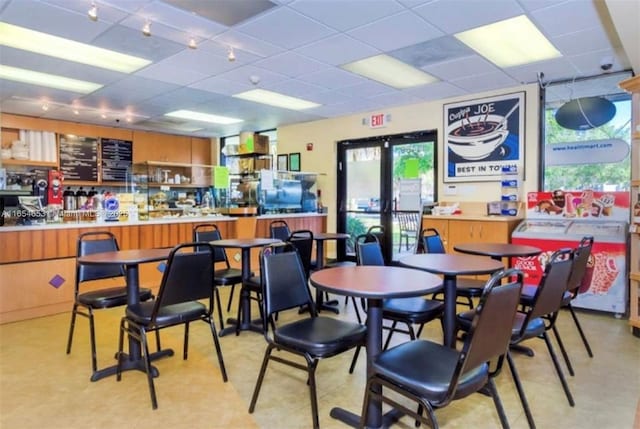 dining area featuring a paneled ceiling