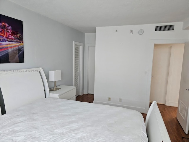 bedroom with dark wood-type flooring