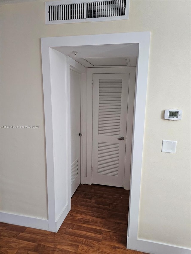 hall with dark wood-type flooring