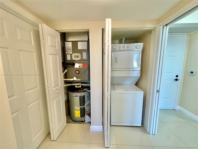 laundry room with stacked washer / dryer, light tile patterned floors, electric water heater, and heating unit