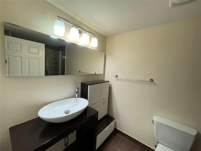 bathroom featuring vanity, toilet, and tile patterned floors