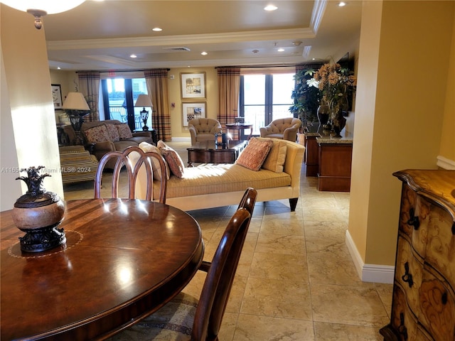 dining area featuring ornamental molding, a tray ceiling, and plenty of natural light