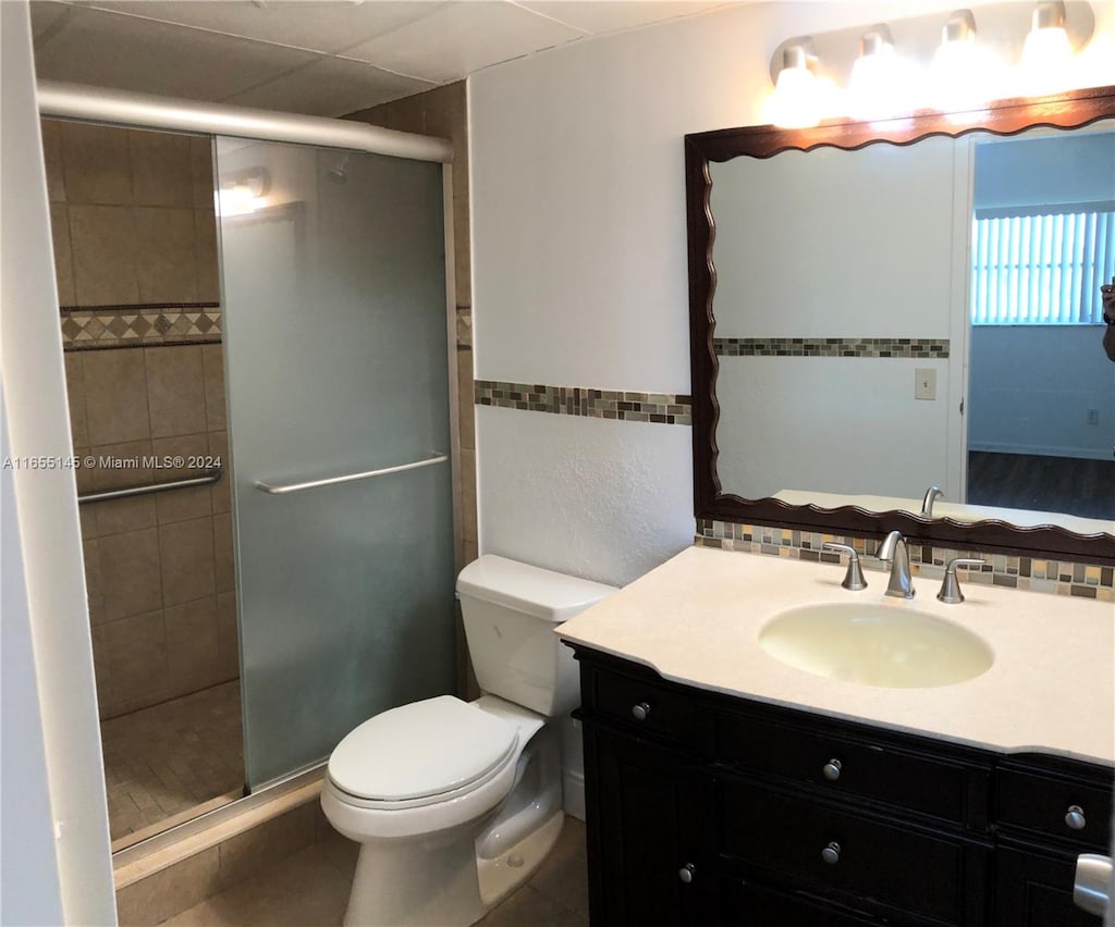 bathroom featuring vanity, toilet, and walk in shower