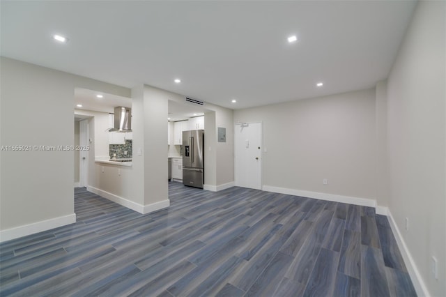 empty room with baseboards, dark wood-type flooring, visible vents, and recessed lighting