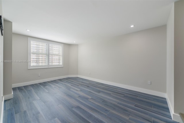 spare room with recessed lighting, dark wood-style flooring, and baseboards